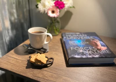 coffee, cake slices and book on a desk