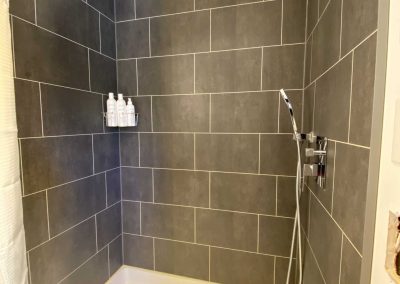 shower room with gray tiles