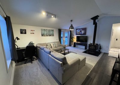 seating are with large sofa, TV, office desk and fireplace