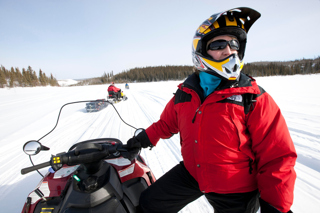 man sitting on a snow mobile